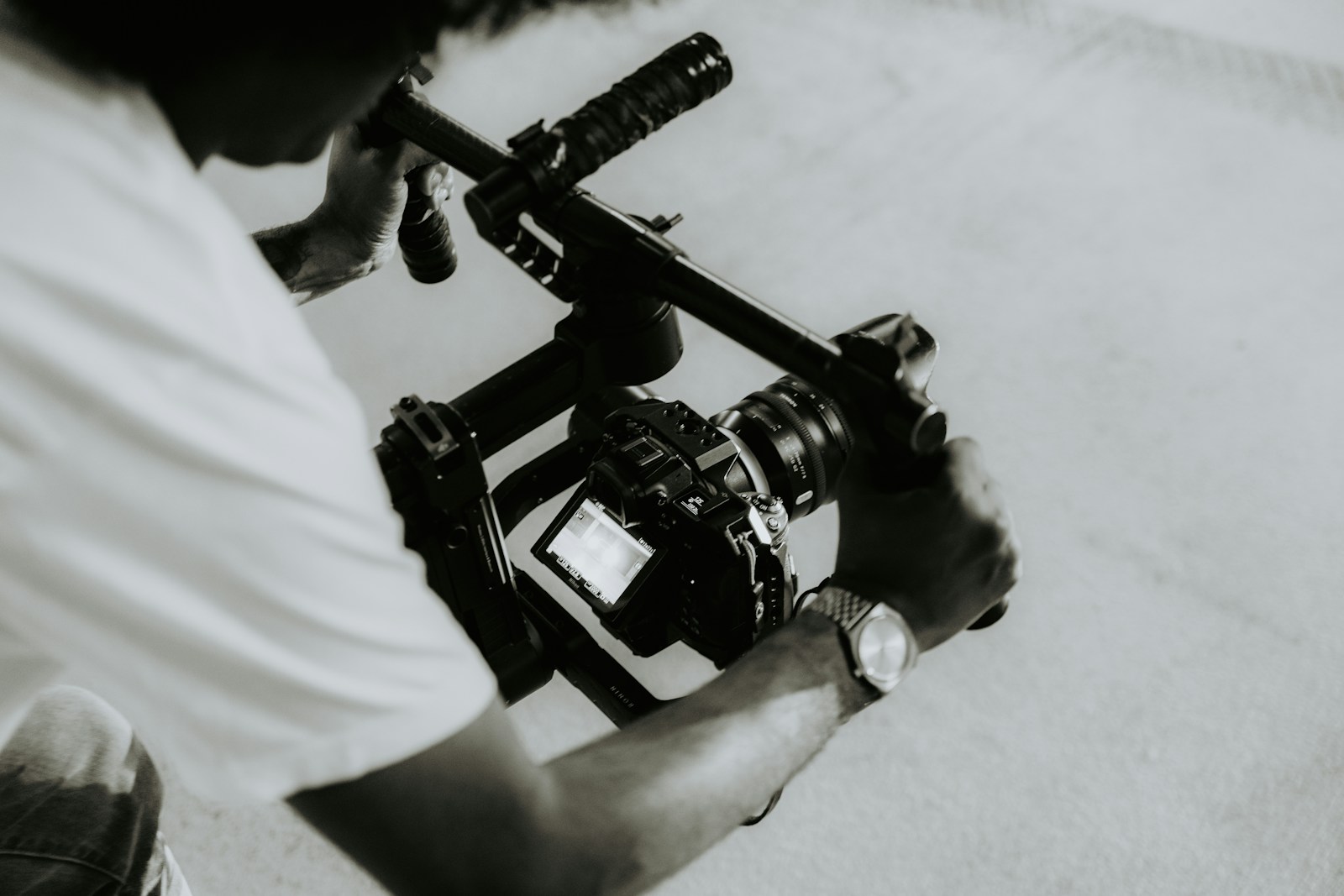 A person is holding a camera on a rig.
